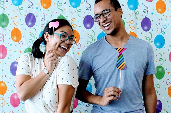 Two smiling grad students at birthday party